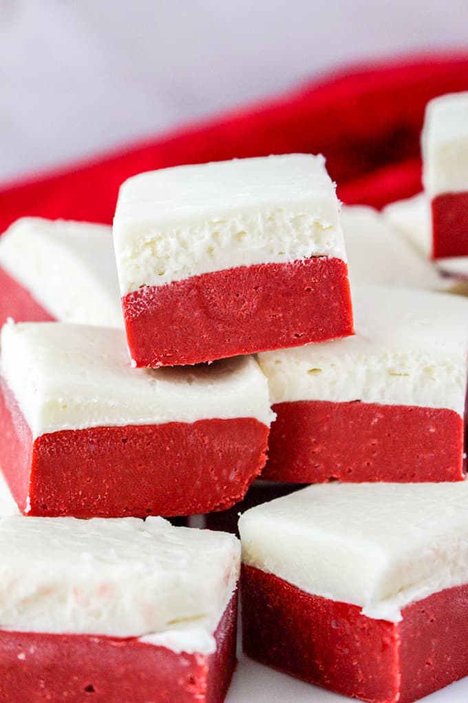 red velvet fudge stacked with a red linen behind it