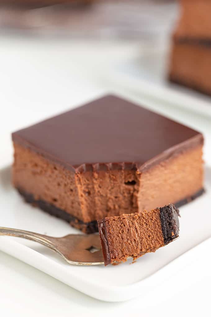 Single Chocolate Cheesecake Bar with bite removed, close-up.