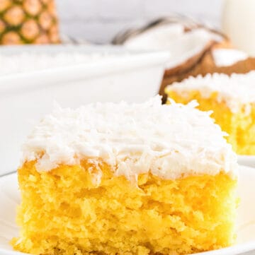 up close shot of a pineapple cake on a white plate with a marble background