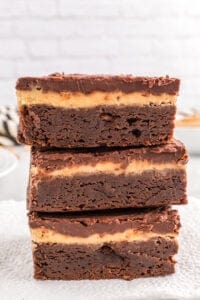A stack of buckeye brownies on a plate.