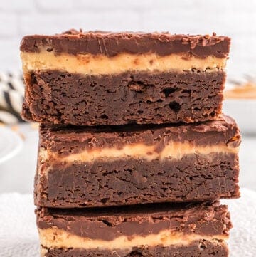 A stack of buckeye brownies on a plate.
