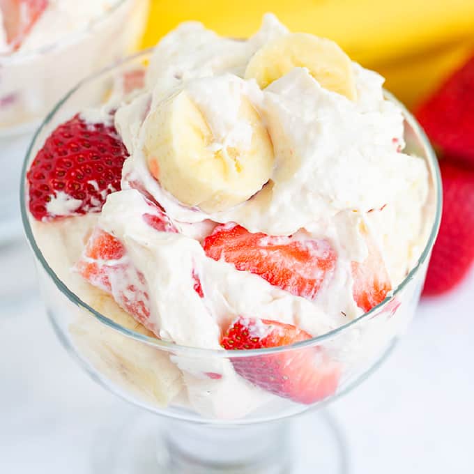 square image of dessert serving glass full of strawberry banana cheesecake fluff