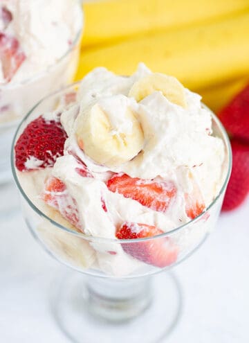A bowl of strawberry banana ice cream with a strawberry banana cheesecake salad topping.