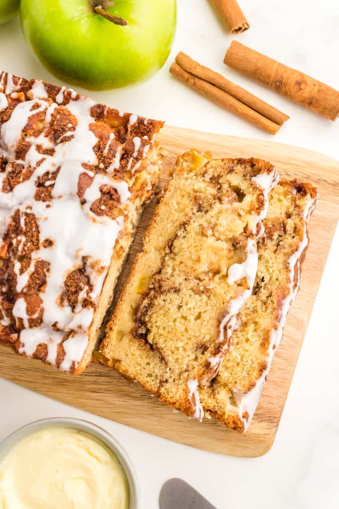 A slice of apple cinnamon bread on a cutting board.