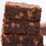 A stack of irresistible chocolate brownies on a sleek white plate, making classic box brownies unforgettable.