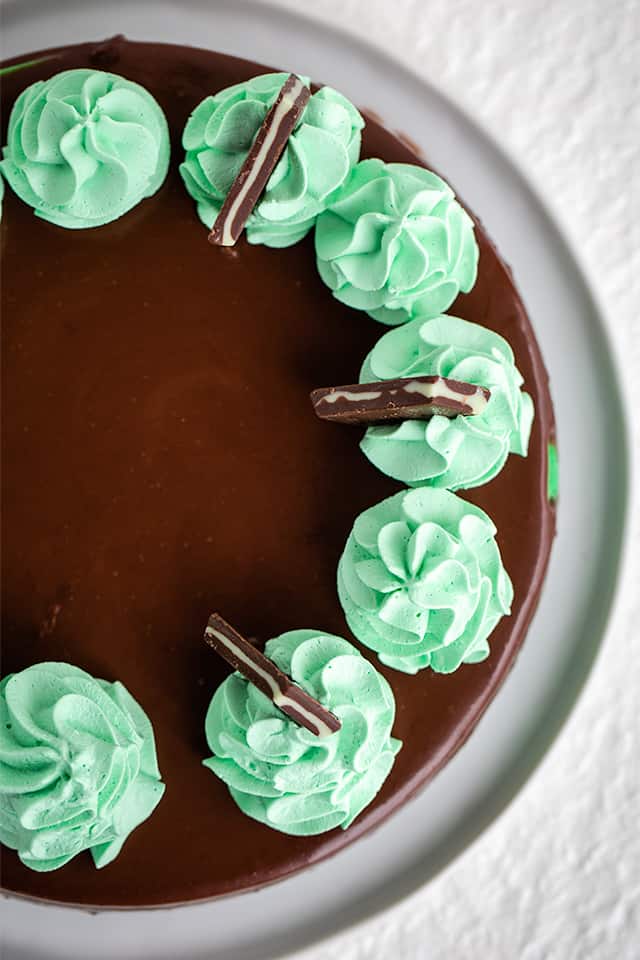 overhead photo of mint chocolate cheesecake on white background