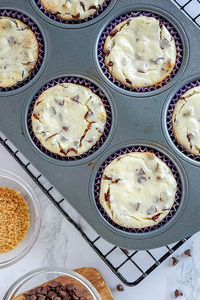 freshly baked cheesecakes in a cupcake pan