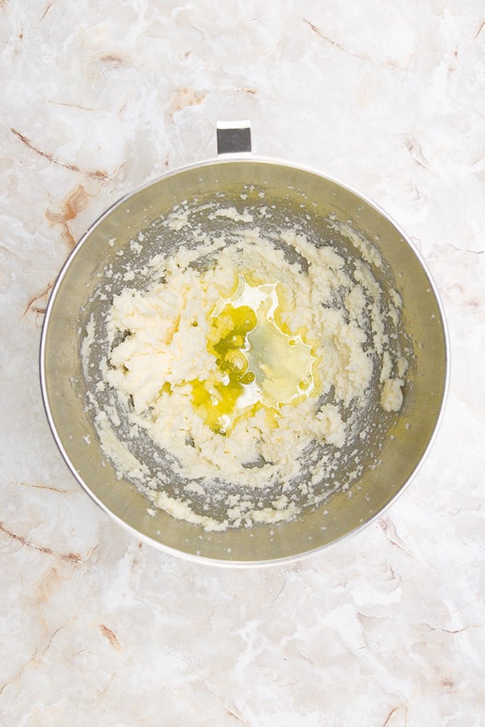 Lime Slime Cupcakes being prepared in a mixing bowl on a marble countertop.