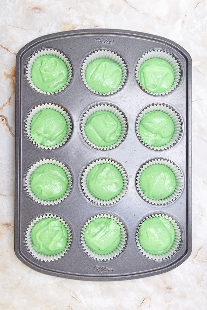 Lime cupcakes in a muffin tin.