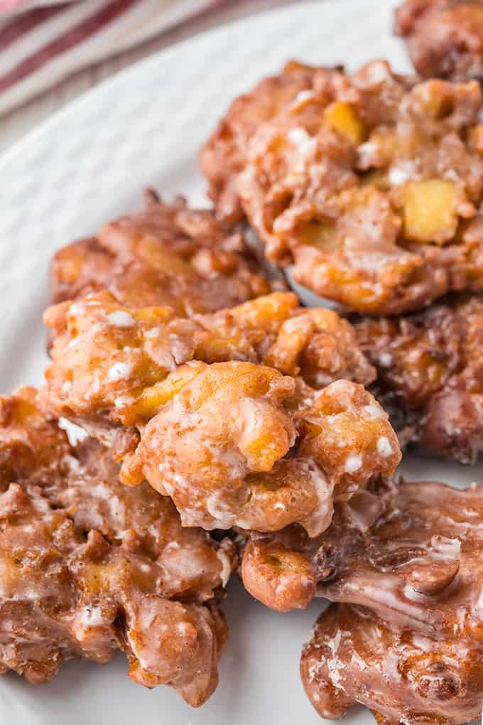 A plate of apple fritters on a white plate.