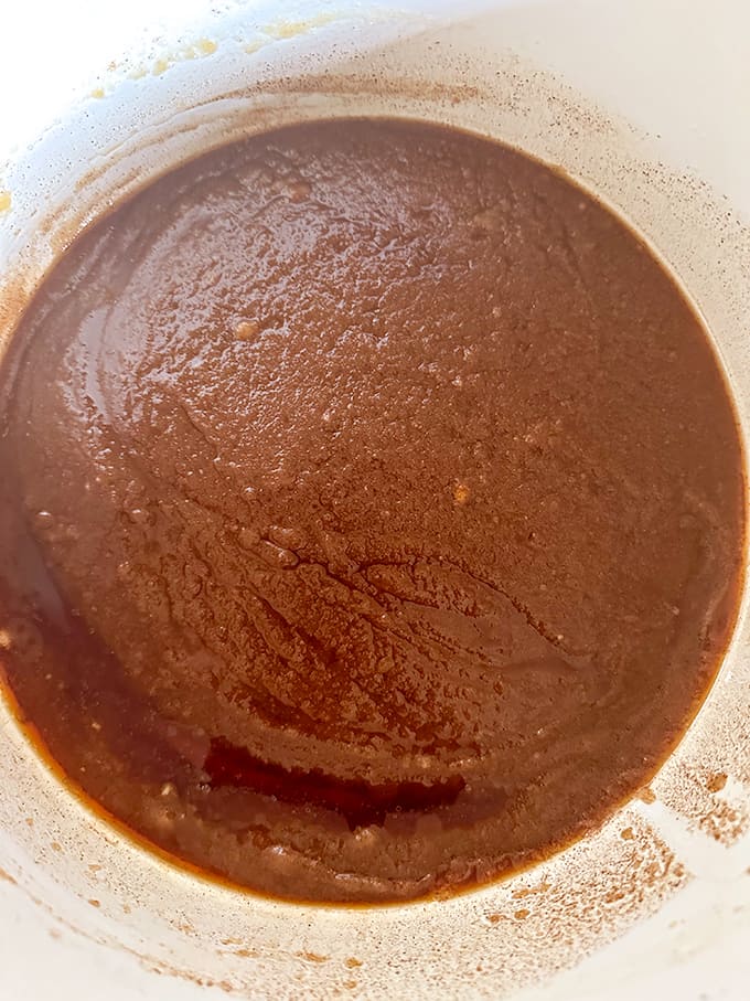 A bowl of cinnamon  sugar mixture in a white saucepan