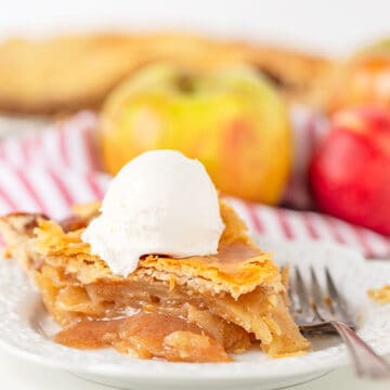 The best apple pie with a scoop of ice cream on a plate.