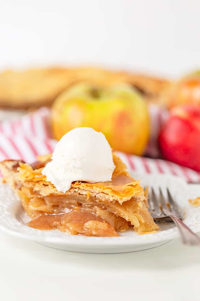 The best apple pie with a scoop of ice cream on a plate.