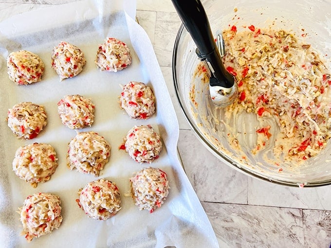 A baking sheet with Martha Washington Candy cookies on it and a spatula.