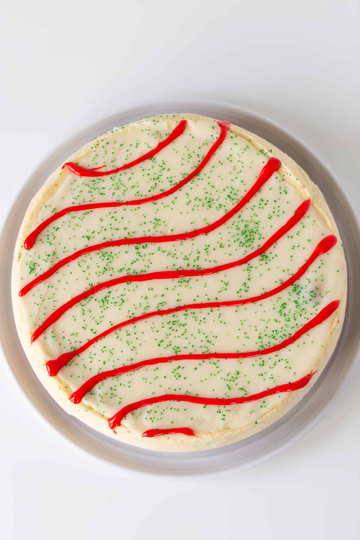 A Little Debbie Christmas Tree Cheesecake on a white plate on a white surface