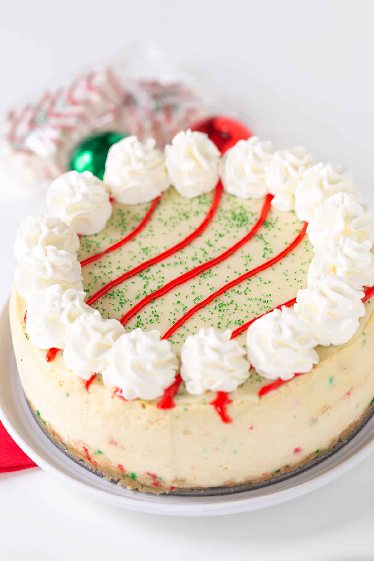 A Little Debbie Christmas Tree Cheesecake on a plate with candy canes.