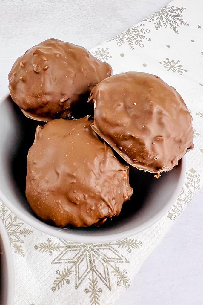 Three Martha Washington Candies in a bowl next to a napkin.