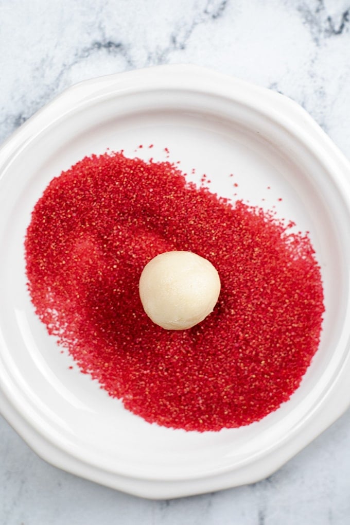 A plate with a red egg on it, resembling a festive ornament.