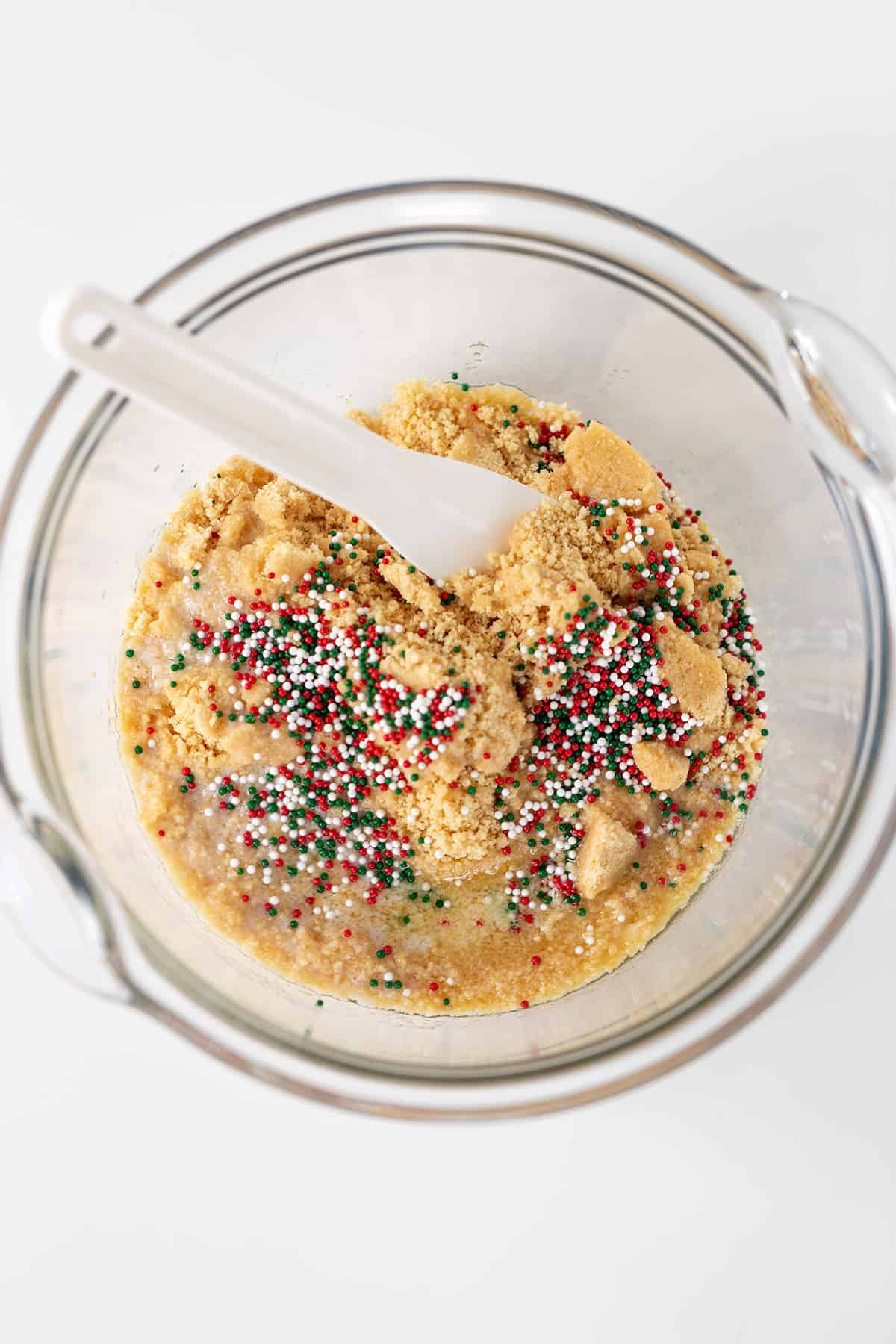 A festive bowl of cookie dough with colorful sprinkles reminiscent of Little Debbie's Christmas Tree Cheesecake.