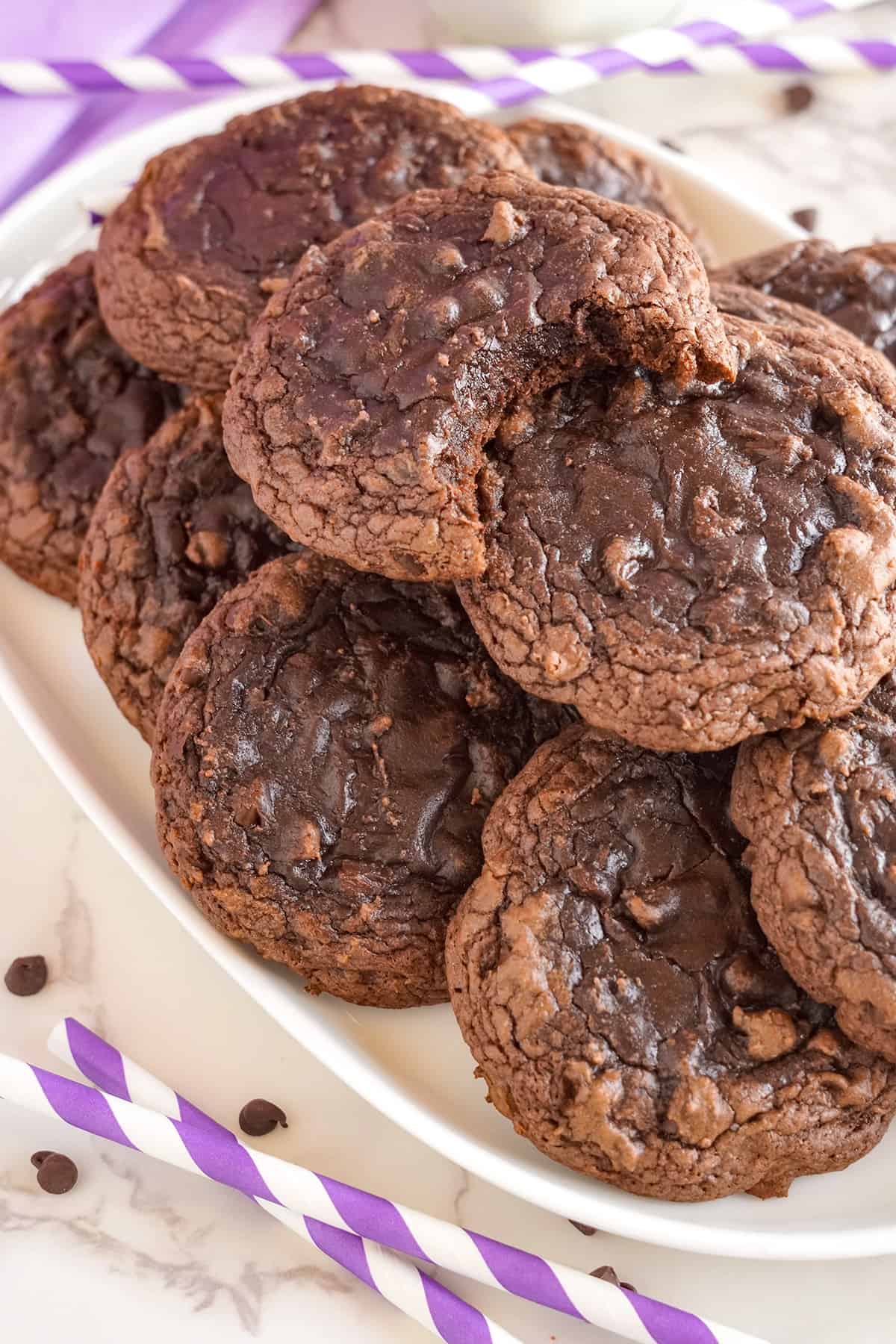 Brownie mix cookies stacked on a white plate.