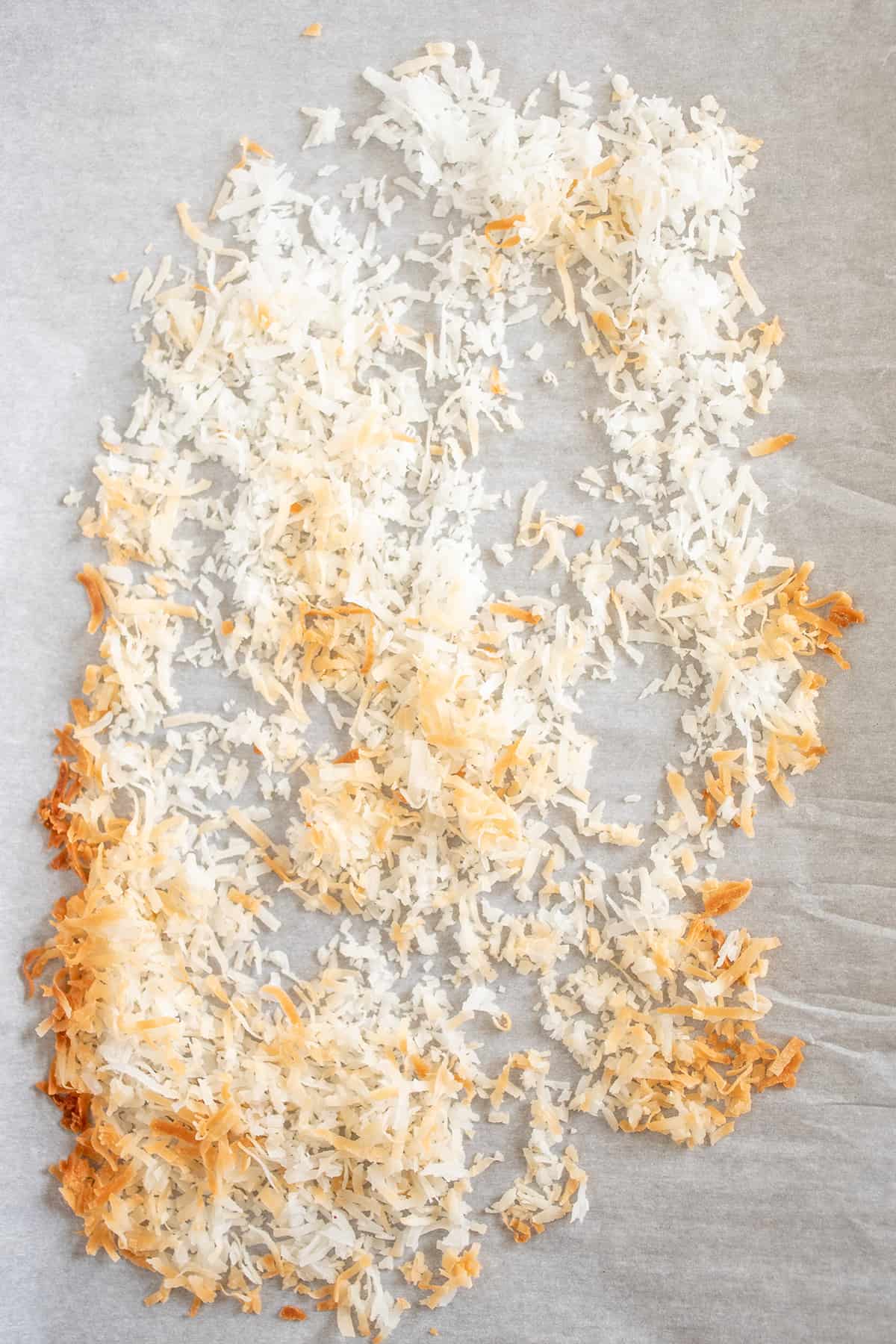 shredded coconut on a baking sheet with parchment paper that's been toasted