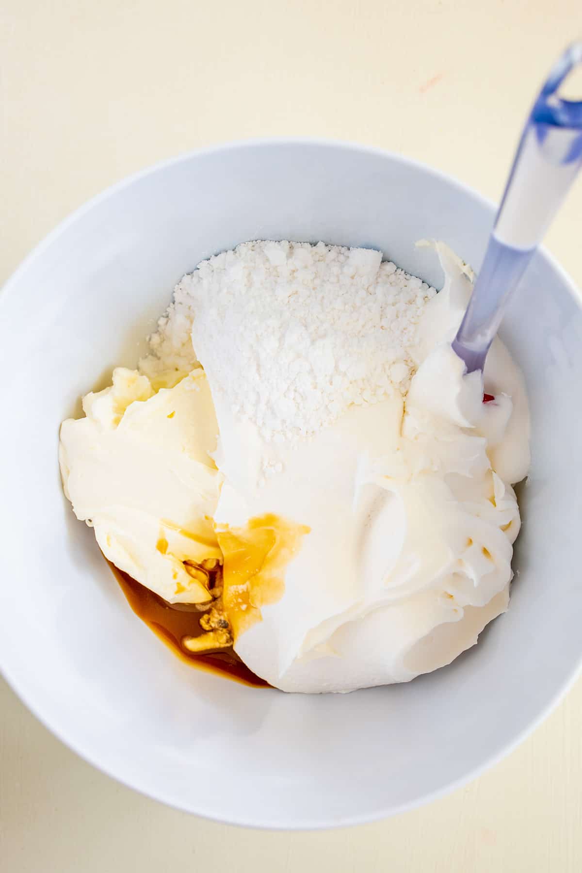 A bowl containing ingredients such as flour, eggs, butter, and coconut cream dip, likely in preparation for baking.