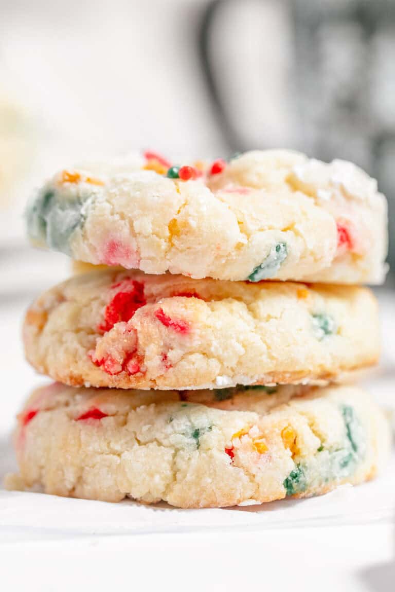 Three stacked Gooey Butter Cookies with colorful sprinkles, featuring a soft, crumbly texture.