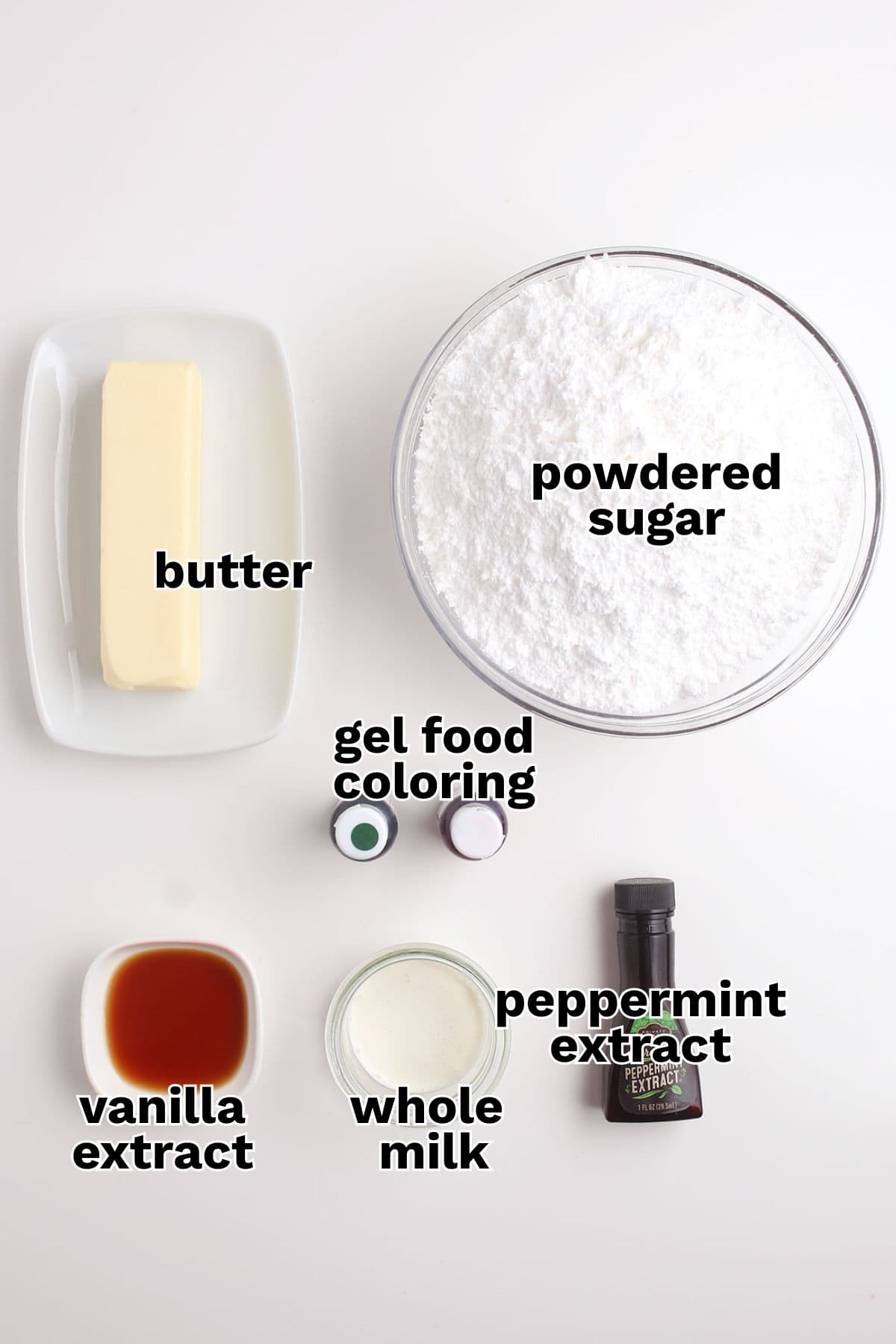 A stick of butter, powdered sugar, gel food coloring, vanilla and peppermint extract, and whole milk are arranged on a white surface&mdash;everything you need to make delicious homemade mints or buttery-soft Homemade Butter Mints.