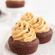 A brown cupcake topped with silky Peanut Butter Cream Cheese Frosting.