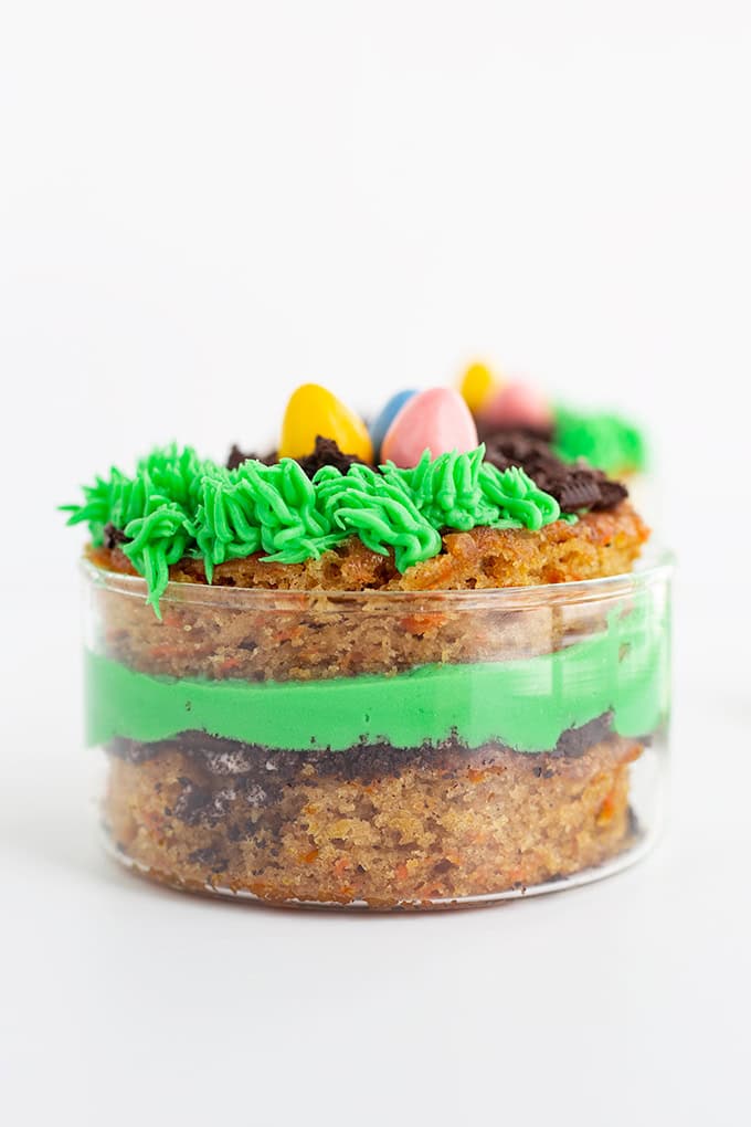 A delightful Mini Easter Trifle, this jar dessert features layers of cake, green frosting, chocolate crumble, and colorful candy eggs&mdash;perfect for anyone searching for festive Easter desserts or mini trifle recipes.