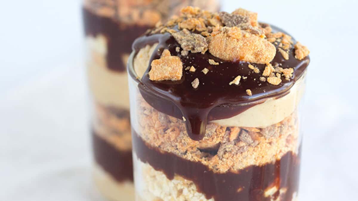 A delicious no bake dessert, this layered treat in a glass features chocolate sauce, crushed candy, and creamy filling&mdash;topped with more chocolate sauce and candy pieces. Perfect for winter desserts or any easy desserts craving.