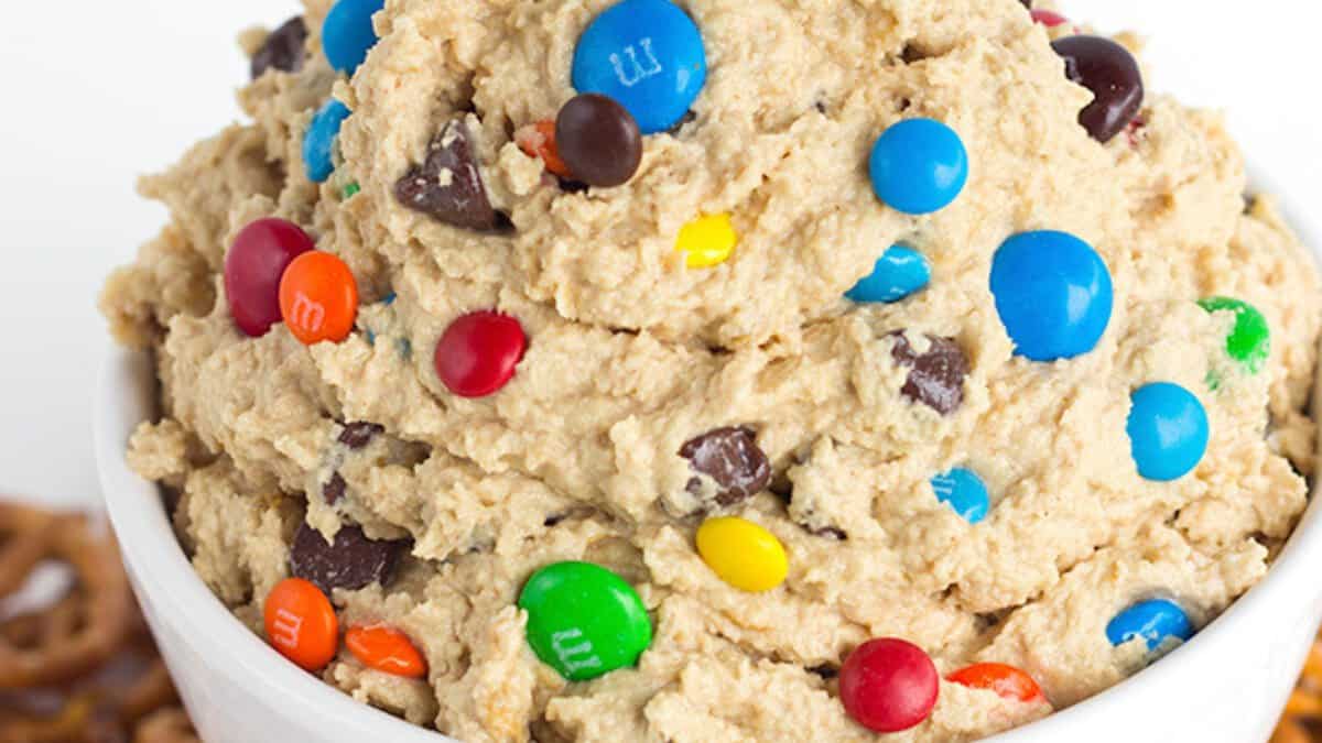 A bowl filled with cookie dough mixed with chocolate chips and colorful candy-coated chocolates&mdash;one of the easiest no bake desserts for winter.