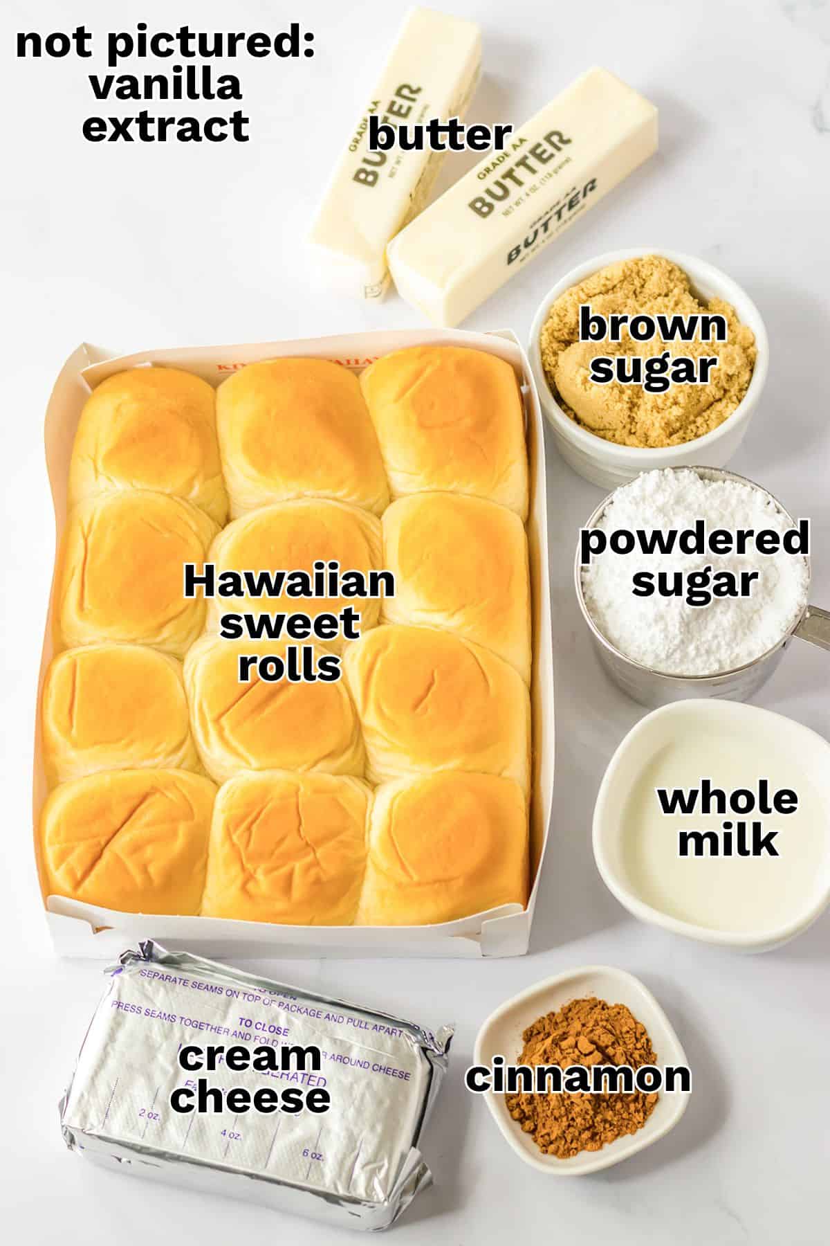 Box of Hawaiian sweet rolls surrounded by butter, brown sugar, powdered sugar, whole milk, cream cheese, and cinnamon on a white surface—perfect ingredients for creating irresistible Hawaiian Roll cinnamon rolls; vanilla extract not pictured.