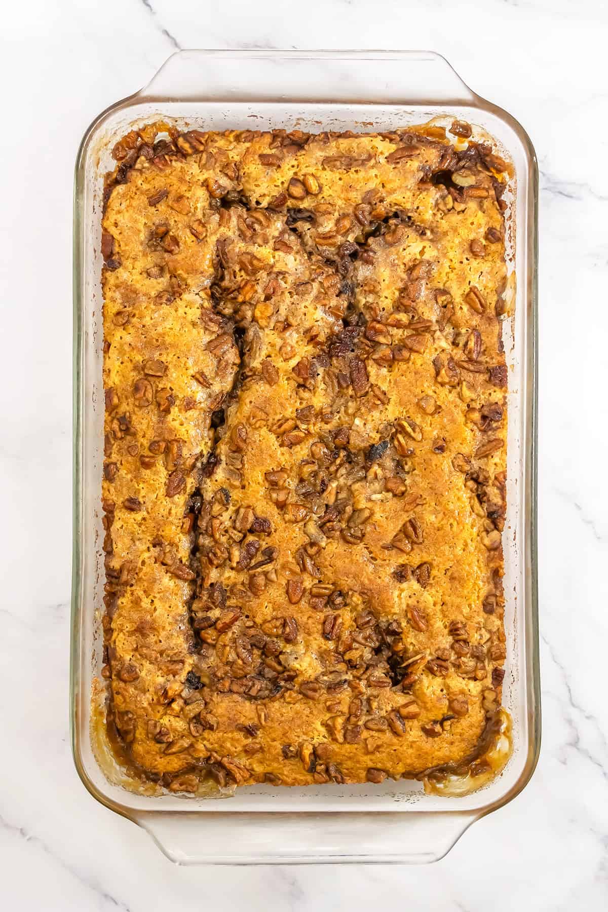Baked pumpkin pecan pudding in a rectangular glass baking dish.